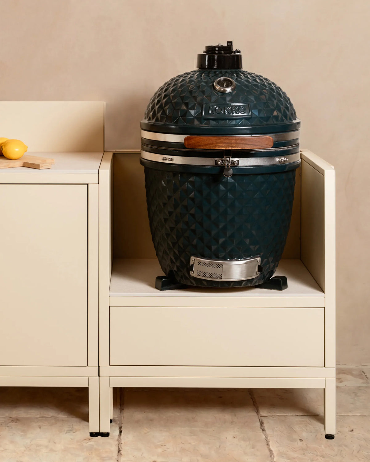 Kamado em cerâmica azul-marinho Kokko instalado em módulo beige creme PILOTIS, cozinha exterior